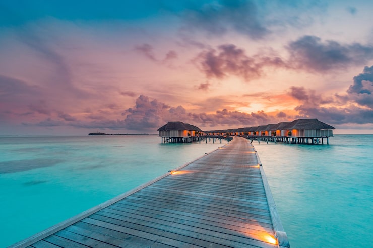 Maldives overwater villas at sunset